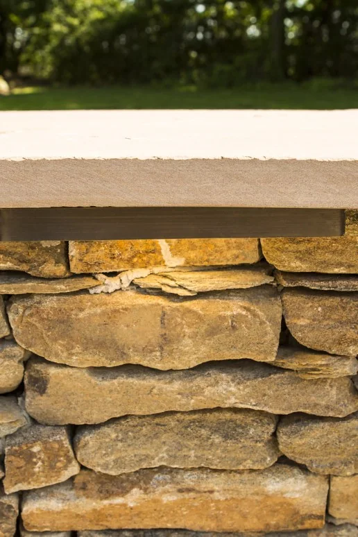 Coastal Source hardscape marker light in a stone wall