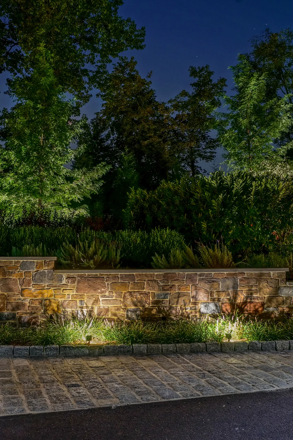 Coastal Source wall wash light across a stone façade